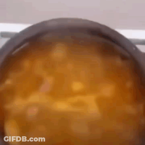 A Pot Of Soup Is Being Cooked On A Stove GIF