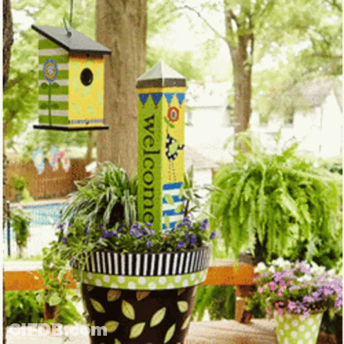 A Potted Plant With A Welcome Sign Hanging From It GIF