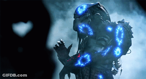 A Predator With Blue Lights Around His Body GIF