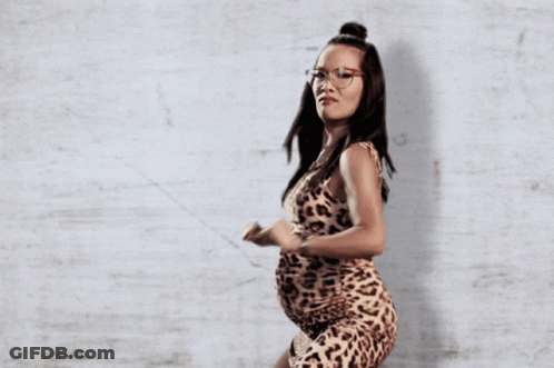A Pregnant Woman In A Leopard Print Dress GIF