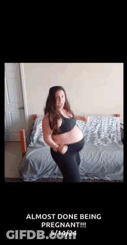 A Pregnant Woman Is Dancing On A Bed With The Words `` Almost Done Being Pregnant '' Written On The Bottom . GIF