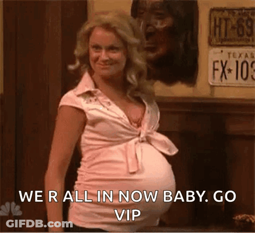 A Pregnant Woman Is Standing In Front Of A Wall With A License Plate That Says Fx-109 GIF