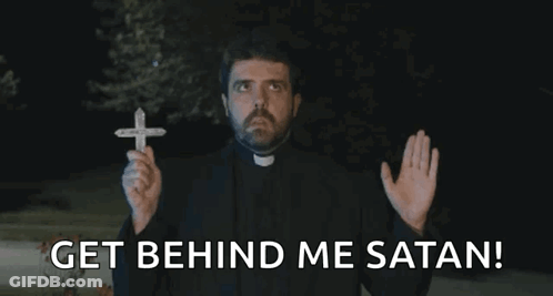 A Priest Holding A Cross With The Words Get Behind Me Satan GIF