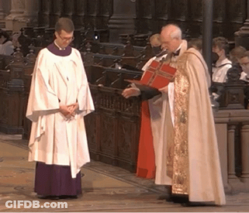 A Priest In A White Robe Is Talking To Another Priest GIF