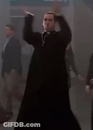 A Priest Is Dancing In A Dark Room With A Group Of People Behind Him . GIF