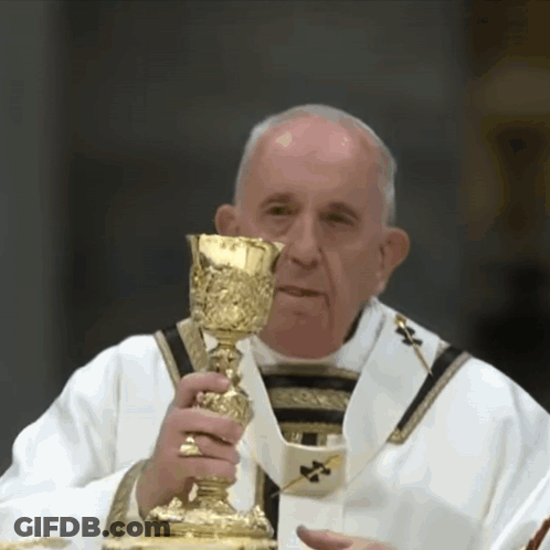 A Priest Is Holding A Golden Chalice In His Hand GIF