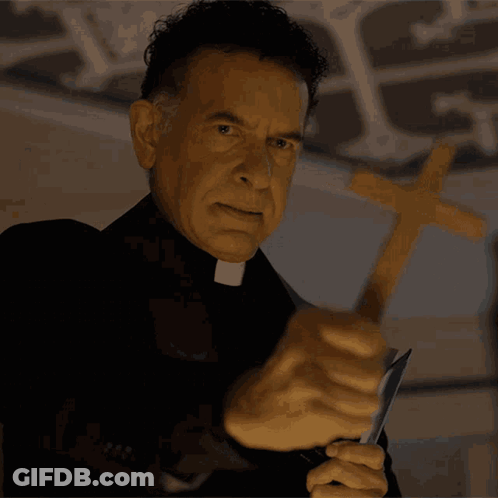 A Priest Is Holding A Knife And A Cross In His Hands GIF