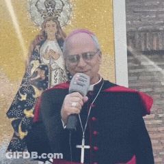 A Priest Is Holding A Microphone In Front Of A Painting GIF