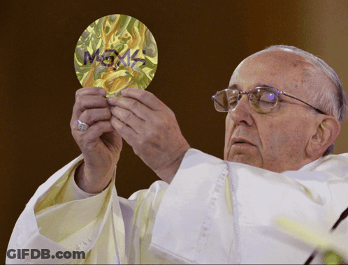 A Priest Is Holding A Piece Of Paper That Says ' Megas ' On It GIF