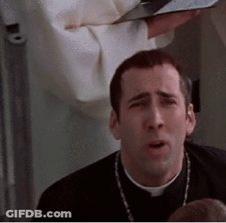 A Priest Is Making A Funny Face While Holding A Bible In His Hands . GIF