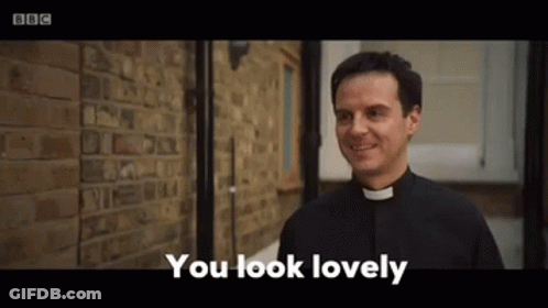 A Priest Is Standing In Front Of A Brick Wall And Smiling While Saying `` You Look Lovely '' . GIF