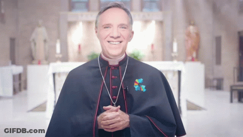 A Priest Wearing A Blue Cape With A Cross On His Chest GIF