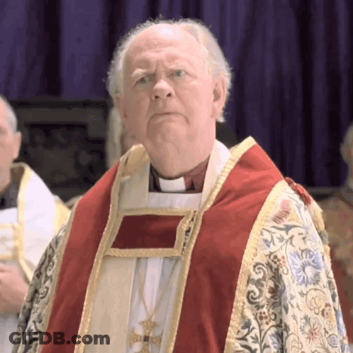 A Priest Wearing A Red And Gold Robe Stands In Front Of A Purple Background GIF