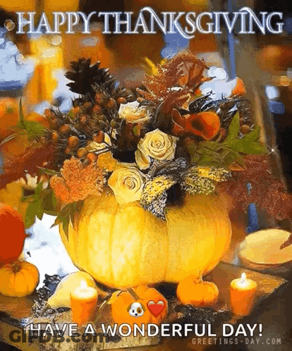 A Pumpkin Filled With Flowers And Candles Is On A Table With A Happy Thanksgiving Message . GIF