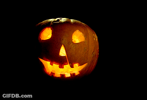 A Pumpkin With A Face Carved Into It Is Lit Up GIF