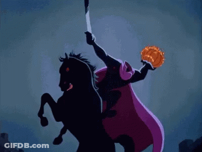 A Pumpkin With A Face Carved Into It Is On Fire In A Barn GIF