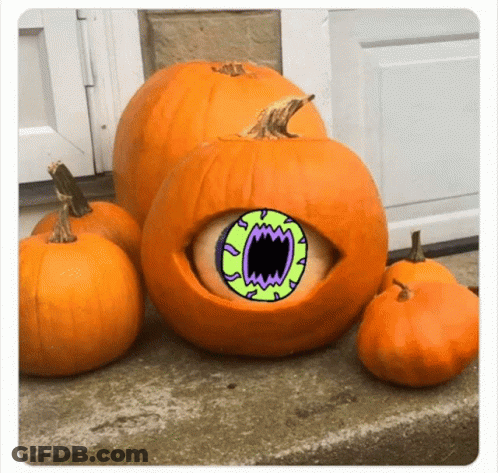 A Pumpkin With A Green Eye And Mouth Is Surrounded By Smaller Pumpkins . GIF