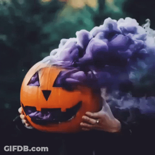 A Pumpkin With Purple Smoke Coming Out Of It GIF