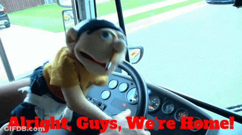 A Puppet Driving A Bus With The Words " Alright Guys We 'Re Home " GIF
