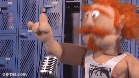 A Puppet Is Holding A Microphone And Pointing GIF