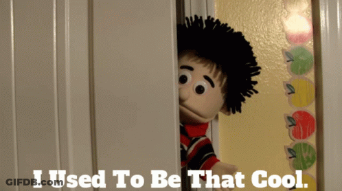 A Puppet Is Peeking Out Of A Door With The Words " I Used To Be That Cool " Below It GIF