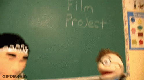 A Puppet Is Standing In Front Of A Blackboard That Says Film Project GIF