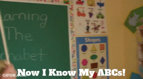 A Puppet Is Standing In Front Of A Chalkboard That Says Learning The Alphabet Now I Know My Abcs GIF