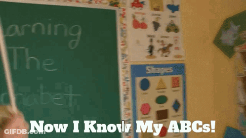 A Puppet Is Standing In Front Of A Chalkboard That Says Learning The Alphabet Now I Know My Abcs GIF
