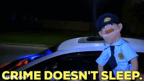 A Puppet Police Officer Is Standing In Front Of A Police Car With The Words Crime Does N't Sleep GIF