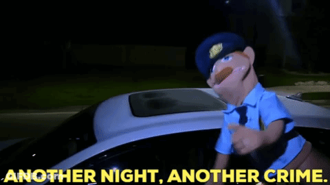 A Puppet Police Officer Standing Next To A Police Car With The Words Another Night Another Crime GIF