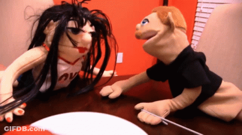 A Puppet Wearing A Shirt That Says " Love " On It GIF