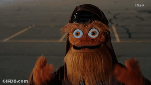 A Puppet With A Beard And Big Eyes Is Wearing A Helmet GIF
