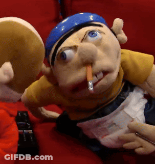 Puppet With Cigarette Laying On Red Couch GIF