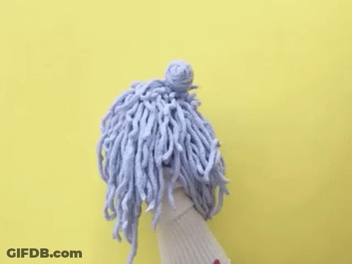 A Puppet With A Mop On Its Head And The Words `` Baller Time '' Written Above It . GIF