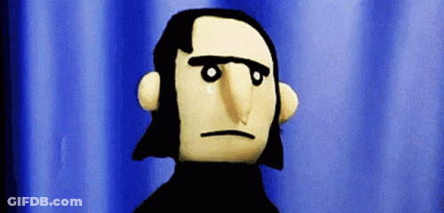 A Puppet With A Serious Look On His Face Is Standing In Front Of A Blue Curtain GIF