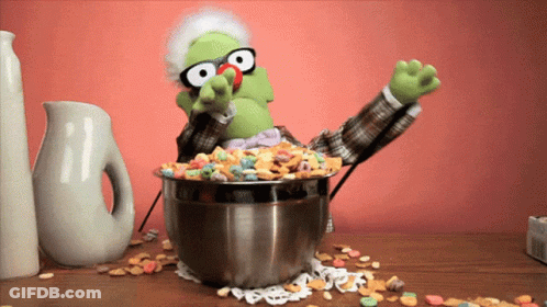 A Puppet With Glasses And A Bowl Of Cereal GIF