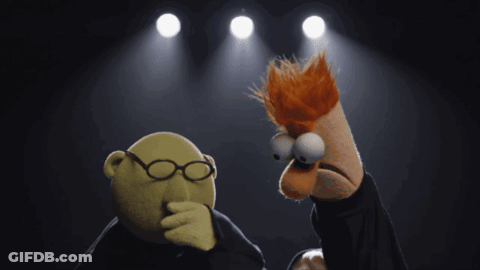 A Puppet With Glasses Is Standing Next To Another Puppet With Red Hair GIF