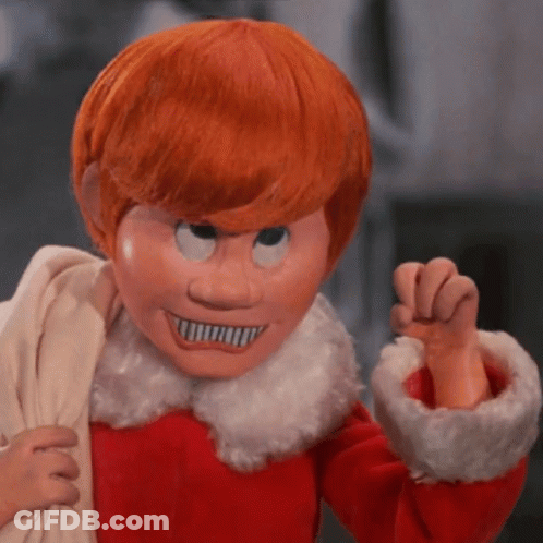 A Puppet With Red Hair And A White Collar Is Wearing A Mask GIF