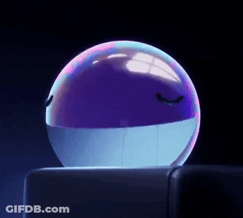 A Purple And Blue Ball With A Face On It Is Sitting On A Table . GIF