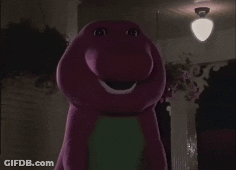A Purple And Green Stuffed Animal With A Big Smile GIF