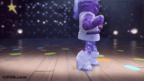 A Purple And White Cartoon Character Is Dancing On A Stage GIF