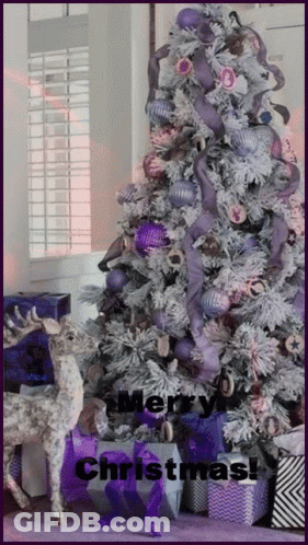A Purple And White Christmas Tree With The Words Merry Christmas On It GIF