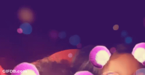 A Purple Background With A Bunch Of Pink Circles Floating In The Air GIF