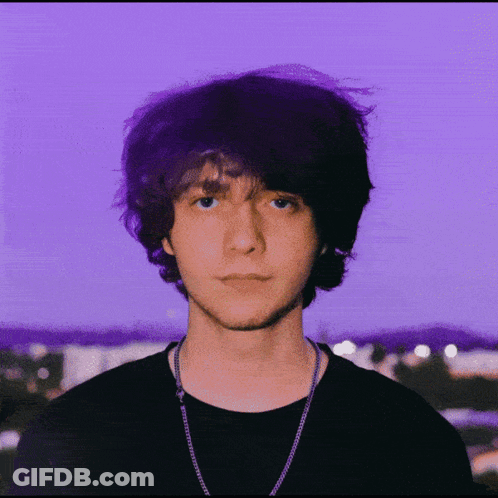 A Purple Background With A Man Wearing Glasses GIF