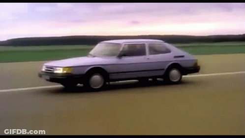 A Purple Car Is Driving Down A Road GIF