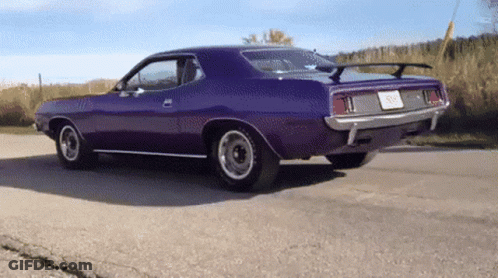 A Purple Car Is Parked On The Side Of The Road And Has A License Plate That Says ' Sd ' On It GIF