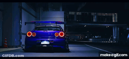 A Purple Car Is Parked On The Side Of The Road With Makeagif.com Written On The Bottom GIF