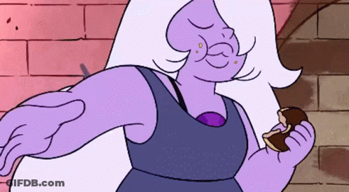 A Purple Cartoon Character Is Holding A Piece Of Chocolate GIF