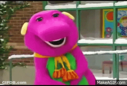 A Purple Dinosaur Is Standing In Front Of A Brick Building Holding A Bag . GIF