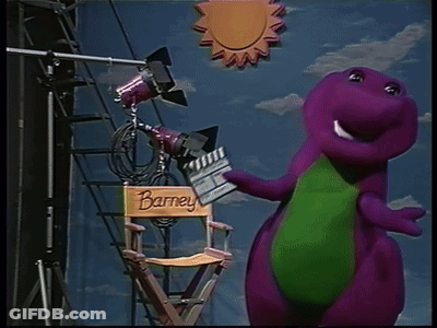 A Purple Dinosaur Is Standing Next To A Director 'S Chair With The Name Barney On It GIF